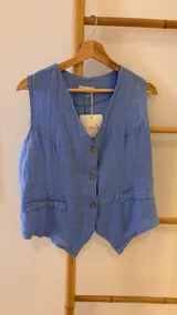 Chaleco celeste de lino con corte sastrero y botones de coco.