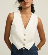 Chaleco color crudo confeccionado en sarga con botones delanteros de escudo y pences. Este producto posee algodón certificado BCI en su composición, siendo ambientalmente más sostenible.