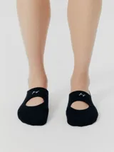 Medias negras con diseño de calzado Mary Jane y logo bordado en blanco.