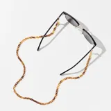 Correa para lentes color carey con eslabones pequeños y cierre dorado.