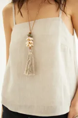 Top de lino color beige, de escote recto y breteles finos, con calce holgado.
