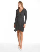 Vestido corto de seda fría con estampado botánico en blanco y negro. Presenta escote en V cruzado, mangas largas entalladas, cintura elastizada con aplique metálico lateral y ruedo asimétrico.