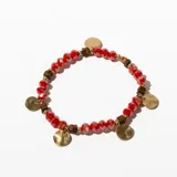 Pulsera elástica con cuentas facetadas de cristal rojo, cuentas doradas y cuentas de madera color marrón. Incluye dijes circulares dorados.