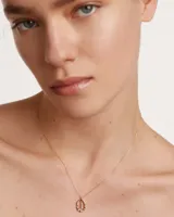 Collar de plata de ley bañado en oro de 18k con un colgante ovalado adornado con circonitas multicolor y una letra L en el centro.