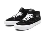 Championes de skate Vans modelo Half Cab, color negro con suela blanca. Presentan diseño de media caña, confeccionados en gamuza y lona, con costuras blancas visibles y parche lateral característico.