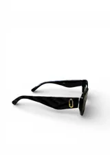 Lentes de sol Aurum con armazón negro de diseño anguloso, lentes oscuras y detalles dorados en las patillas.