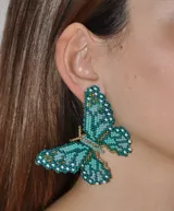 Aros colgantes con forma de mariposa hechos a mano con mostacillas de colores celeste, azul y dorado.