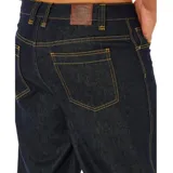 Pantalón de jean Rip Curl modelo Premium Surf Raw Denim, color azul marino oscuro, de corte holgado y costuras en contraste.