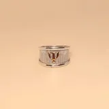 Anillo de banda ancha con textura rugosa en plata, destacando el símbolo de psicología en relieve en oro 18k en el centro.