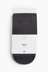 Medias de lycra negras transparentes con hilos plateados brillantes en la trama y cintura elástica estándar.