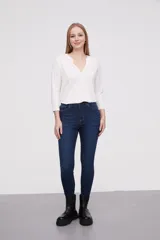 Pantalon jean de corte skinny y tiro alto, color azul clásico con costuras en tono ocre.