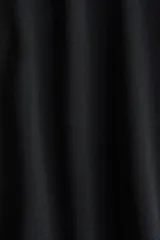 Pantalón globo negro de punto de crepé, con corte relajado, cintura elástica de tiro bajo con cordón ajustable y puños anchos en las piernas.
