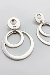 Aros colgantes dorados formados por múltiples aros concéntricos con textura estriada.