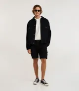 Bermuda cargo negra confeccionada en sarga de algodón, con cintura tradicional, cierre de cremallera y botón, y bolsillos laterales útiles.