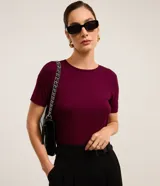Blusa básica de viscosa color bordó, de manga corta, escote redondo y diseño liso al cuerpo.