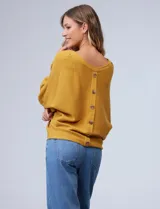 Buzo marca Cupio de tejido acanalado color azul. Tiene mangas largas estilo dolman y aplique de botones en la espalda.