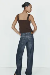 Top corto de tejido de punto color marrón oscuro, con escote cuadrado y tirantes anchos. Presenta un detalle de calado tipo crochet en el ruedo con borde festoneado.