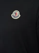 Remera de algodón de corte clásico, color negro, con cuello redondo y logo de la marca aplicado en el pecho.