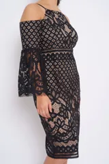 Vestido midi de encaje negro con forro color piel, hombros descubiertos y mangas acampanadas.