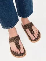 Sandalia tipo ojota de cuero negro con diseño de tira central con nudo y base de corcho.