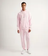 Pantalón deportivo de algodón y poliéster color rosa claro, con cordón ajustable en la cintura y puños elásticos en los tobillos.
