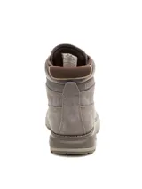 Bota de cuero tipo borceguí en color gris, con diseño robusto y suela de goma dentada inspirada en maquinaria pesada. Cuenta con cordones frontales, cuello acolchado y el logo de la marca grabado en el lateral y en la lengüeta.