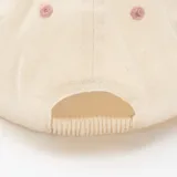 Gorra con visera color rosado y cuerpo en tono beige, con detalle de bordado con el texto "Break Away" en la parte frontal.