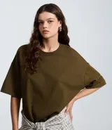 Remera oversize de manga corta en color verde militar, con cuello redondo y diseño liso de estilo casual.
