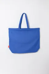 Tote bag de tela azul con estampado de la inscripción 'New York' en negro, diseño amplio con doble asa de hombro.