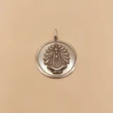 Dije redondo de plata 925 con la imagen en relieve de la Virgen de Luján.