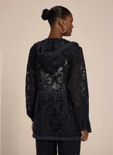 Campera con capucha confeccionada en tejido liso con encaje, con transparencia, corte ajustado, mangas largas con puños elásticos, cintura con cordón para ajustar y cierre de cremallera frontal.