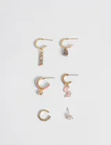 Set de seis aros dorados con diferentes diseños: dos aros tipo argolla con dije colgante de strass, dos aros tipo argolla con dije colgante de corazón y letra 'S' esmaltados en rosa, un aro tipo argolla con strass y un aro solitario con strass.