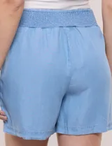 Short celeste confeccionado en lyocell, de corte holgado, con tiro alto, pretina ancha elastizada fruncida y bolsillos laterales.