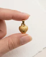 Dije en forma de corazón con diseño estriado vertical, acabado en tono dorado.