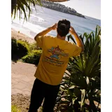 Remera de algodón color mostaza con cuello redondo, manga corta y estampa pequeña en el pecho con el logo de la marca.