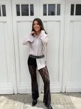 Pantalón de encaje negro con corte acampanado y cintura alta.