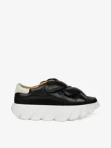 Zapatillas negras de cuero con plataforma blanca y talonera blanca en contraste. Presentan cuatro correas de velcro y suela con dientes de gran formato.