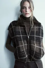 Jersey de punto confeccionado en lana, con cuello subido y manga larga. Presenta un diseño ajustado con detalle de costuras marcadas en el frente.