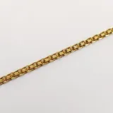 Set de pulseras de oro 18k que incluye dos brazaletes rígidos con texturas diferentes y dos pulseras de cadena fina.