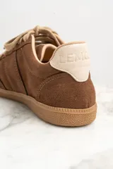 Zapatillas bajas de gamuza color marrón con cordones y suela de goma color caramelo.