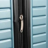 Valija grande rígida de policarbonato color celeste, con cuatro ruedas, candado TSA integrado y compartimento interno con cierre. Marca Munich.