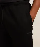 Pantalón deportivo de corte recto, color negro, con cintura elástica ajustable mediante cordón y bolsillos laterales.