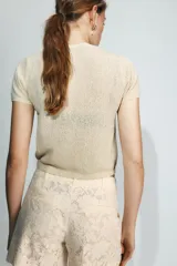 Jersey de punto de cuello redondo y manga corta con acabado en rib.
