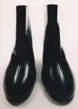 Botin de cuero vacuno color negro, con taco bloque de 5,5 cm, punta redonda y cierre de cremallera en la parte posterior.