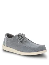 Alpargata Hush Puppies modelo Canyon, color gris con textura tejida. Presenta cordones decorativos y suela de EVA en color crema, diseñada con tecnología ZeroG para mayor ligereza y flexibilidad.