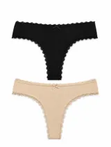 Pack de dos bombachas tipo colaless de algodón, una en color negro y otra en color beige, con detalles de puntilla en los bordes y un pequeño moño decorativo en el centro de la cintura.