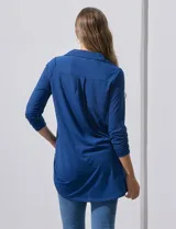 Camisola azul de manga tres cuartos, marca Rio & Rian. Cuello con solapa y abertura central con botones. Manga con detalle fruncido.