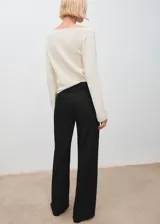 Pantalón de jean negro de corte recto y tiro bajo, con diseño de cinco bolsillos, cierre de botón y cremallera, y trabillas para cinturón.