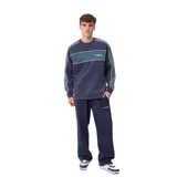 Pantalon de jogging azul marino con franjas laterales en verde y blanco, cintura elástica con cordón ajustable y logo de la marca bordado en la pierna.