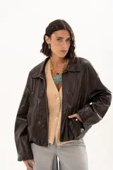 Campera de cuero sintético color chocolate, con cierre frontal, cuello camisero y diseño holgado.